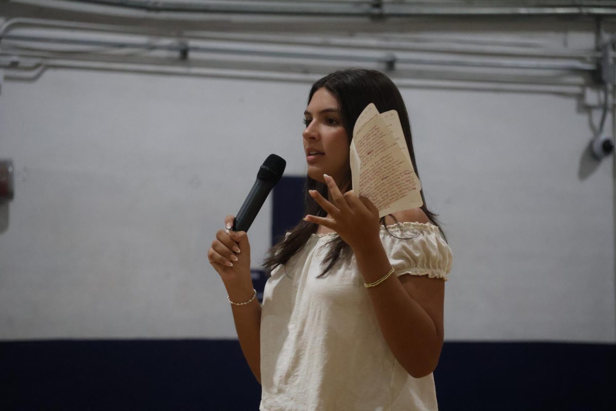 Giving her speech in the gym on Wednesday, April 22, senior class historian candidate Lauren Bender talks about her qualifications. 