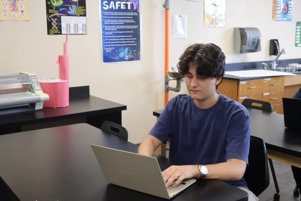 Developing his programming business, sophomore Joseph Pallat works on a Roblox video game on April 6. 